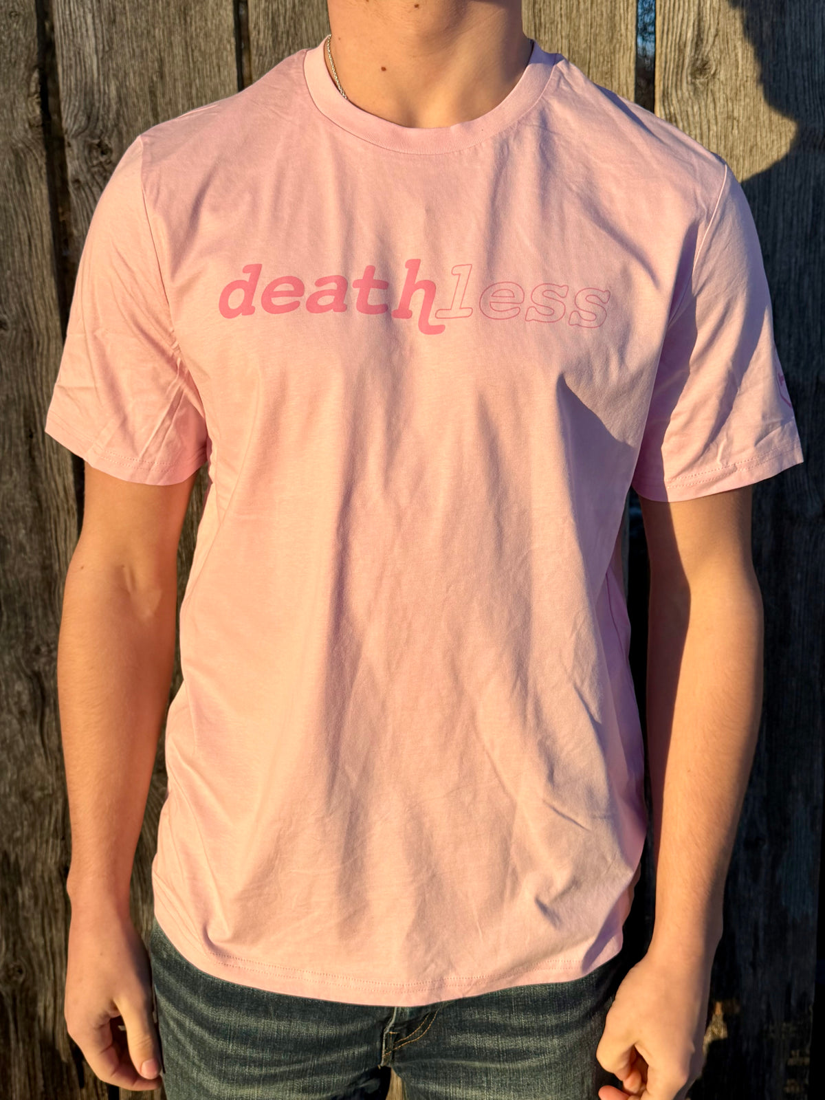 The Deathless Classic tee in pink, worn outdoors